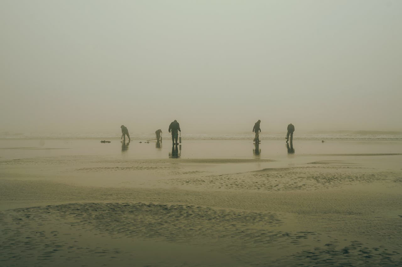 Silhouette of Men on a Foggy Beach